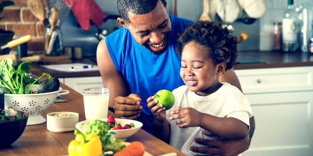 Dad and child making dinner