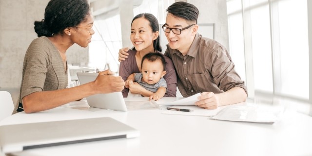 Woman agent showing a family information on a laptop