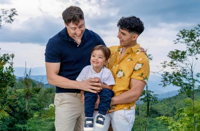 Two parents holding their child