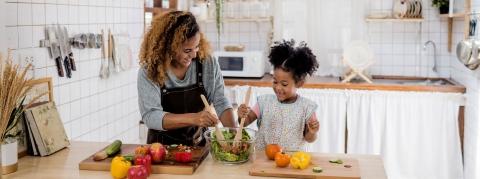 Happy women and child preparing food